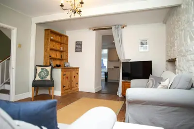 a living room with a couch and a tv at 5 Rock Street New Quay in New Quay