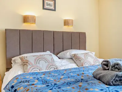 a bed with a large headboard and pillows on it at 3 Bed in Brecon oc-92341 in Brecon