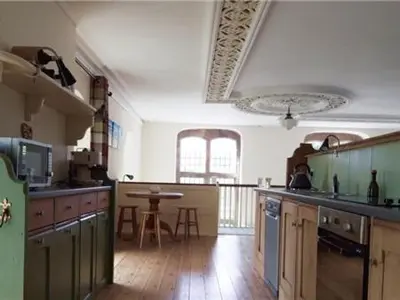 a large kitchen with a table in the middle of it at Capel Pennal in Pennal