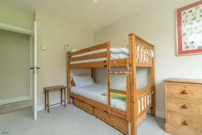 a bedroom with two bunk beds with a ladder at Hendre-Llangwm in Llangwm