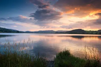 a view of a large lake with a sunset at Hendre-Llangwm in Llangwm