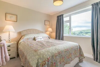 a bedroom with a bed and a window at Hendre-Llangwm in Llangwm
