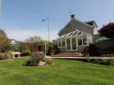 a house with a gazebo in a yard at Llwyn Derw in Talybont