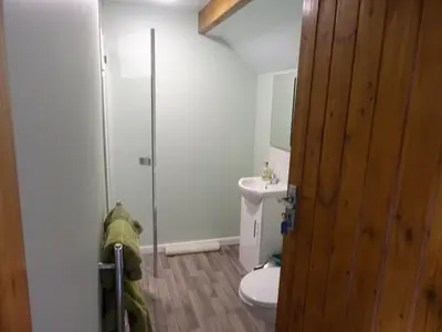 a bathroom with a toilet and a glass shower at Willey Lane Farm in Lingen