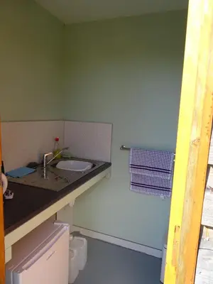 a bathroom with a sink and a green wall at Willey Lane Farm in Lingen