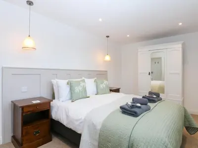 a bedroom with a bed with towels on it at Yr Hen Felin in Dyffryn