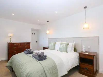 a bedroom with a large bed with towels on it at Yr Hen Felin in Dyffryn