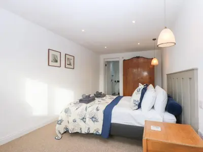 a bedroom with a bed and a table at Yr Hen Felin in Dyffryn