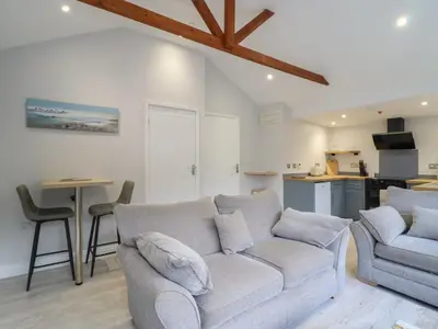 a living room with a couch and a table at Lodge at Nadur in Machynlleth