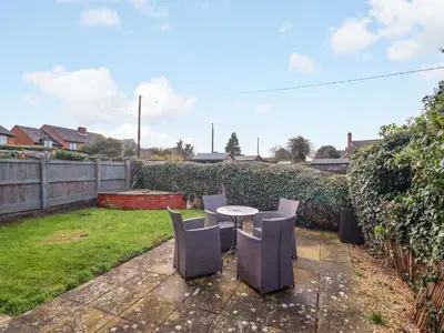 a patio with a table and chairs in a yard at 2 Horseshoe Road in Montgomery