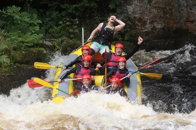 a group of people on a raft in a river at The Granary - Wild Swimming, Sauna, Peace & Quiet, Nr Bala in Corwen