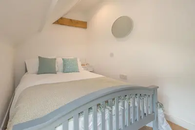 a bedroom with a bed with a crib at Pengwern in Cerrigydrudion
