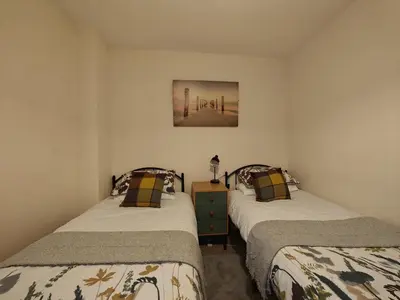 a bedroom with two beds and a painting on the wall at 2 Bed in Llanelltyd oc-s34505 in Llanelltyd