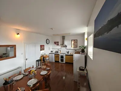 a living room with a table and a kitchen at 2 Bed in Llanelltyd oc-s34505 in Llanelltyd