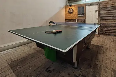 a ping pong table with a ping paddle on it at 2 Bed in Llanelltyd oc-s34505 in Llanelltyd