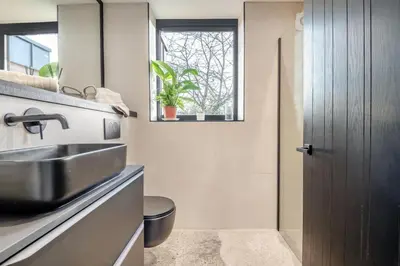 a bathroom with a sink and a toilet and a window at 3 Bed in Leominster oc-w34380 in Leominster