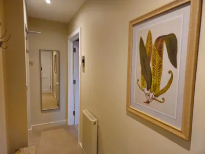 a hallway with a painting of a cactus on the wall at Stylish and newly renovated penthouse apartment - Pass the Keys in Shrewsbury