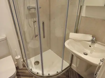a bathroom with a shower and a sink and a toilet at Stylish and newly renovated penthouse apartment - Pass the Keys in Shrewsbury