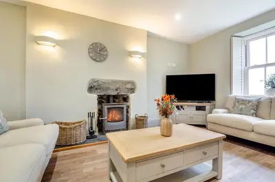 a living room with a fireplace and a tv at 3 Bed in Islawrdref oc-t34600 in Penmaenpool