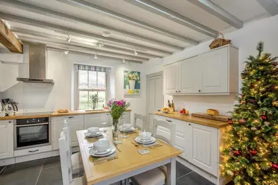 a christmas tree in a kitchen with a table at 3 Bed in Islawrdref oc-t34600 in Penmaenpool