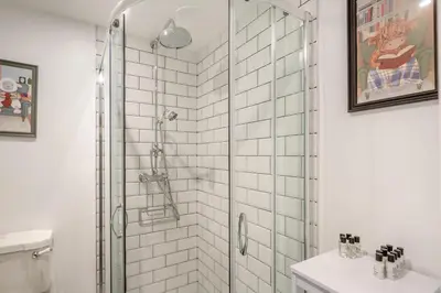 a bathroom with a shower with a glass door at 4 Bed in Ganllwyd oc-g34601 in Mallwyd