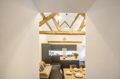 a kitchen and living room with exposed beams at 4 Bed in Ganllwyd oc-g34601 in Mallwyd