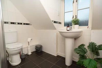 a white bathroom with a toilet and a sink at Professionals welcome - Near Town Centre - Free Parking-Sleeps 4 in Shrewsbury