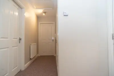 an empty hallway with a white door and a hallway at Professionals welcome - Near Town Centre - Free Parking-Sleeps 4 in Shrewsbury