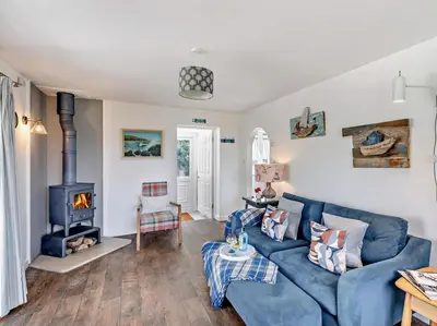 a living room with a blue couch and a stove at 1 Bed in Leominster oc-78638 in Stoke Prior