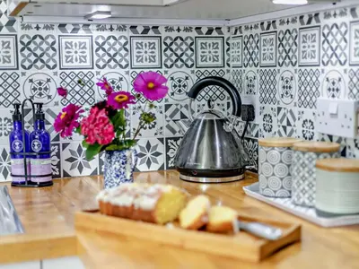 a kitchen counter with a tea kettle and flowers at 1 Bed in Leominster oc-78638 in Stoke Prior