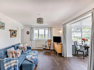 a living room with a blue couch and a desk at 1 Bed in Leominster oc-78638 in Stoke Prior