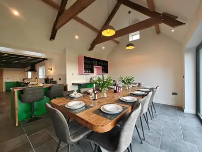 a large dining room with a wooden table and chairs at 7 Bed in Welshpool oc-96412 in Berriew