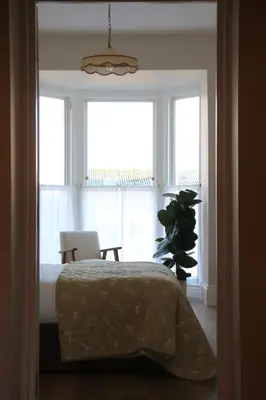 a bedroom with a bed and a window with a chair at Spacious Luxury Apartment in the Heart of Shrewsbury Sleeps 6 in Shrewsbury