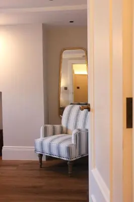 a room with a mirror and a bench with a mirror at Spacious Luxury Apartment in the Heart of Shrewsbury Sleeps 6 in Shrewsbury