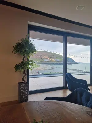 a room with a large window with a potted plant at Premium 3 Bedroom Static Caravan with Sea Views Aber Bay in Aberystwyth