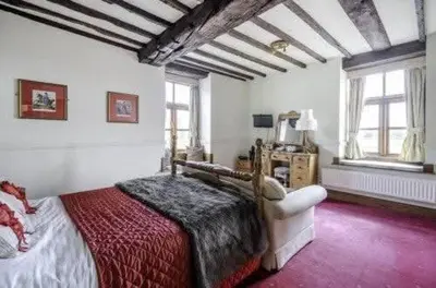 a bedroom with a large bed in a room at Mortimers Cross Guest House in Mortimer's Cross