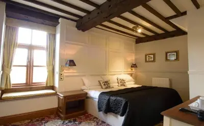 a bedroom with a bed and a window at Mortimers Cross Guest House in Mortimer's Cross