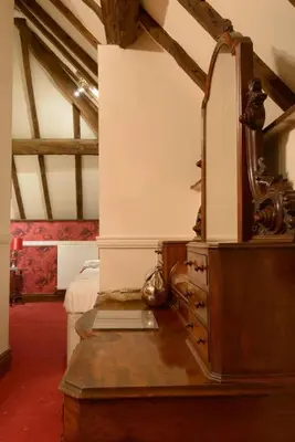 a bedroom with a dresser with a mirror on it at Mortimers Cross Guest House in Mortimer's Cross