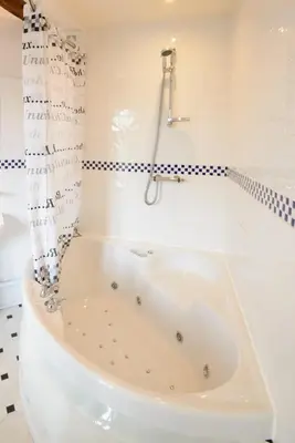 a white bath tub in a bathroom with a shower at Mortimers Cross Guest House in Mortimer's Cross
