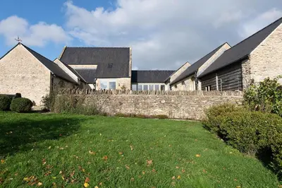 a group of houses behind a stone wall at Blackhill barn - in the heart of the Cotswolds in Craswall