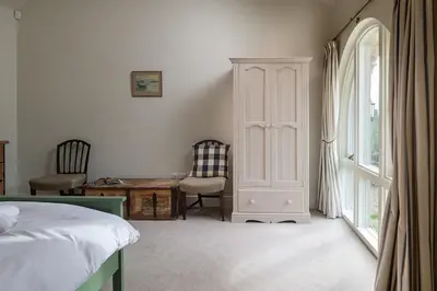 a bedroom with a bed and a desk and a window at Blackhill barn - in the heart of the Cotswolds in Craswall