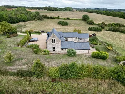 an aerial view of a house in a field at Blackhill barn - in the heart of the Cotswolds in Craswall