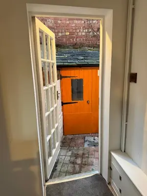 an open door to a building with an orange door at Charming 2 Bed House in Central Shrewsbury in Shrewsbury