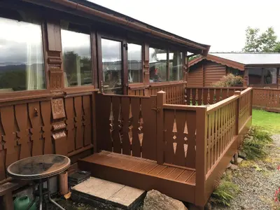 a screened in porch on a house at Log Cabin in Beautiful Snowdonia in Trawsfynydd