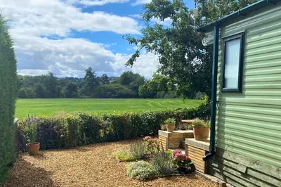 a garden view from the side of a house at Lavender Lodge