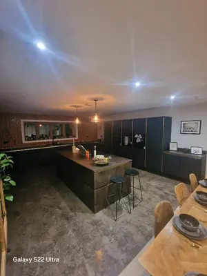 a large kitchen with a large island in a room at Luxurious 5-Bedroom House Rental with Scenic Countryside Views in Hereford