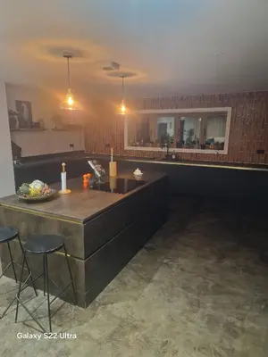 a kitchen with a counter and chairs in a room at Luxurious 5-Bedroom House Rental with Scenic Countryside Views in Hereford