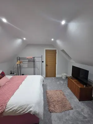 a bedroom with a bed and a flat screen tv at Luxurious 5-Bedroom House Rental with Scenic Countryside Views in Hereford