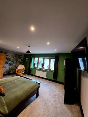 a bedroom with a bed and a flat screen tv at Luxurious 5-Bedroom House Rental with Scenic Countryside Views in Hereford
