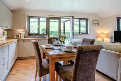 a kitchen and dining room with a table and chairs at 2 Bed in Brecon oc-r33603 in Lower Chapel